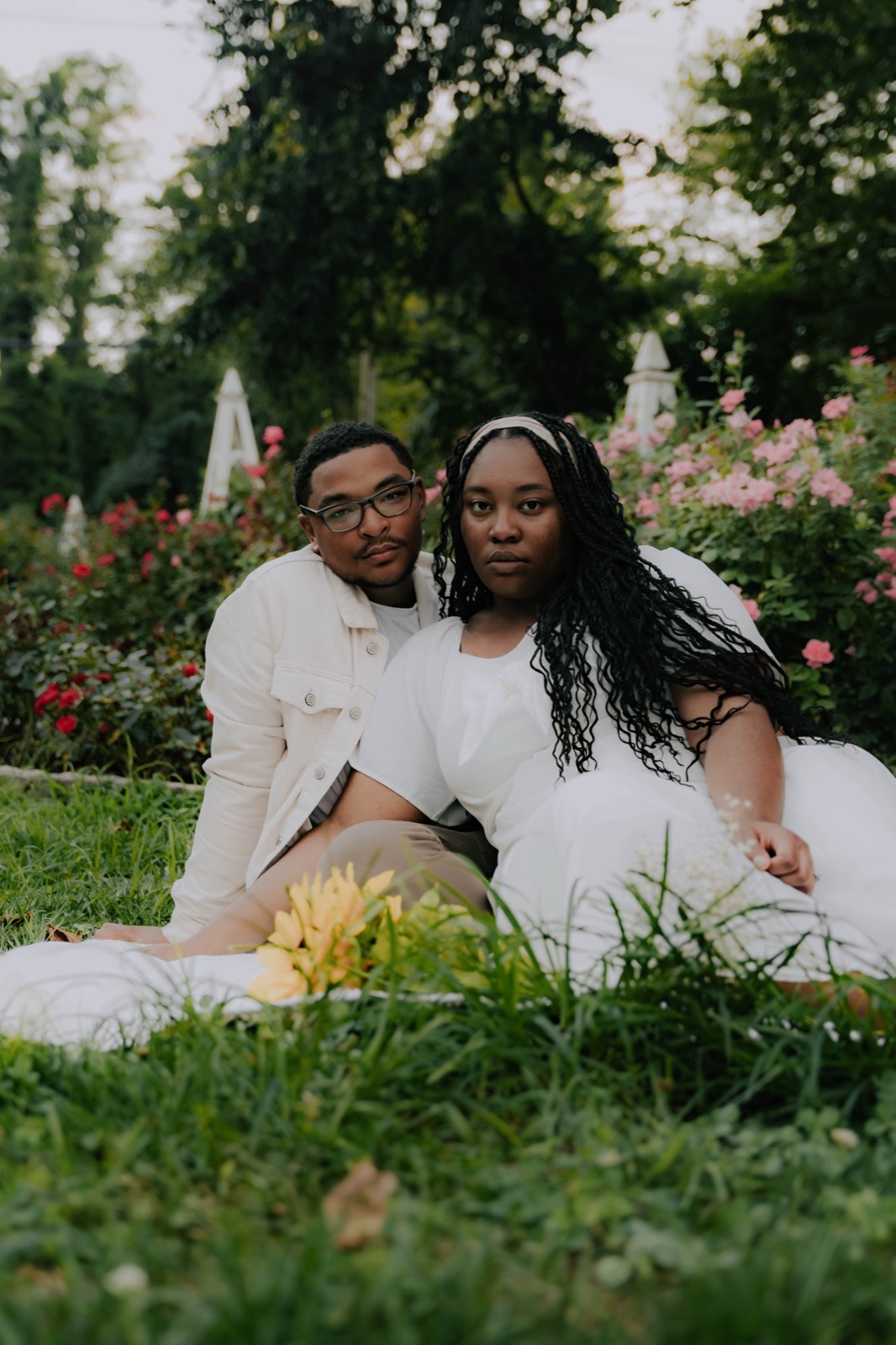 Engaged couple sitting together in a garden