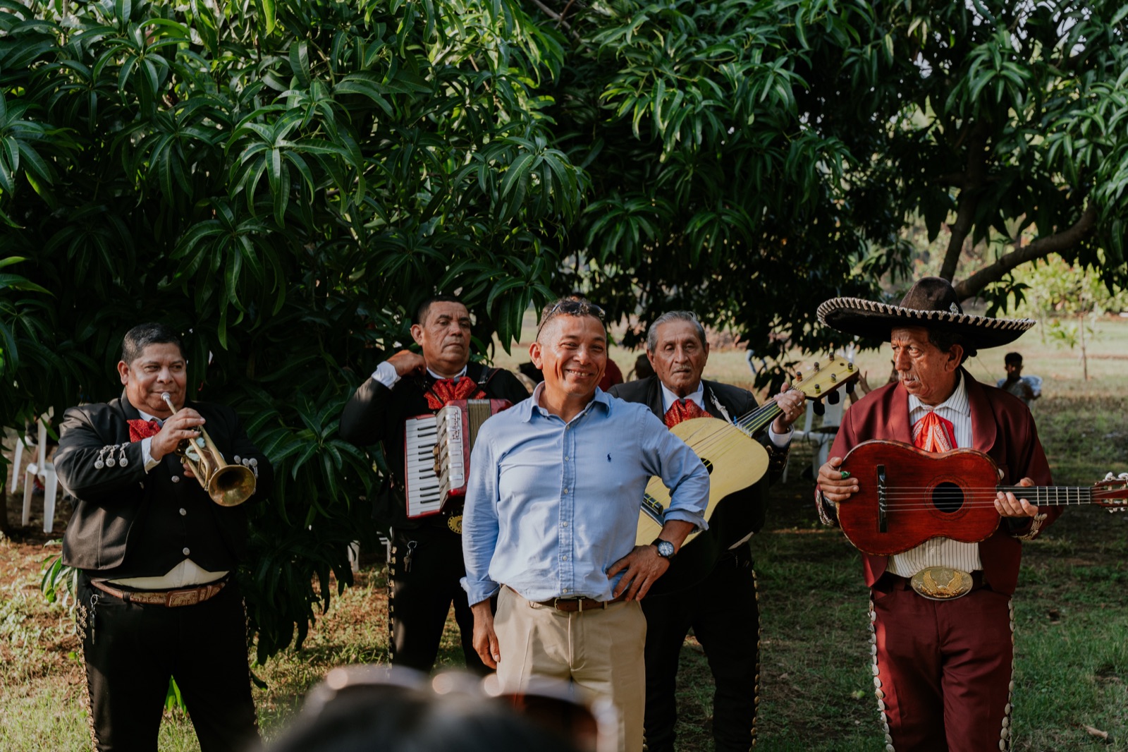 Family posing with a mariachi band
