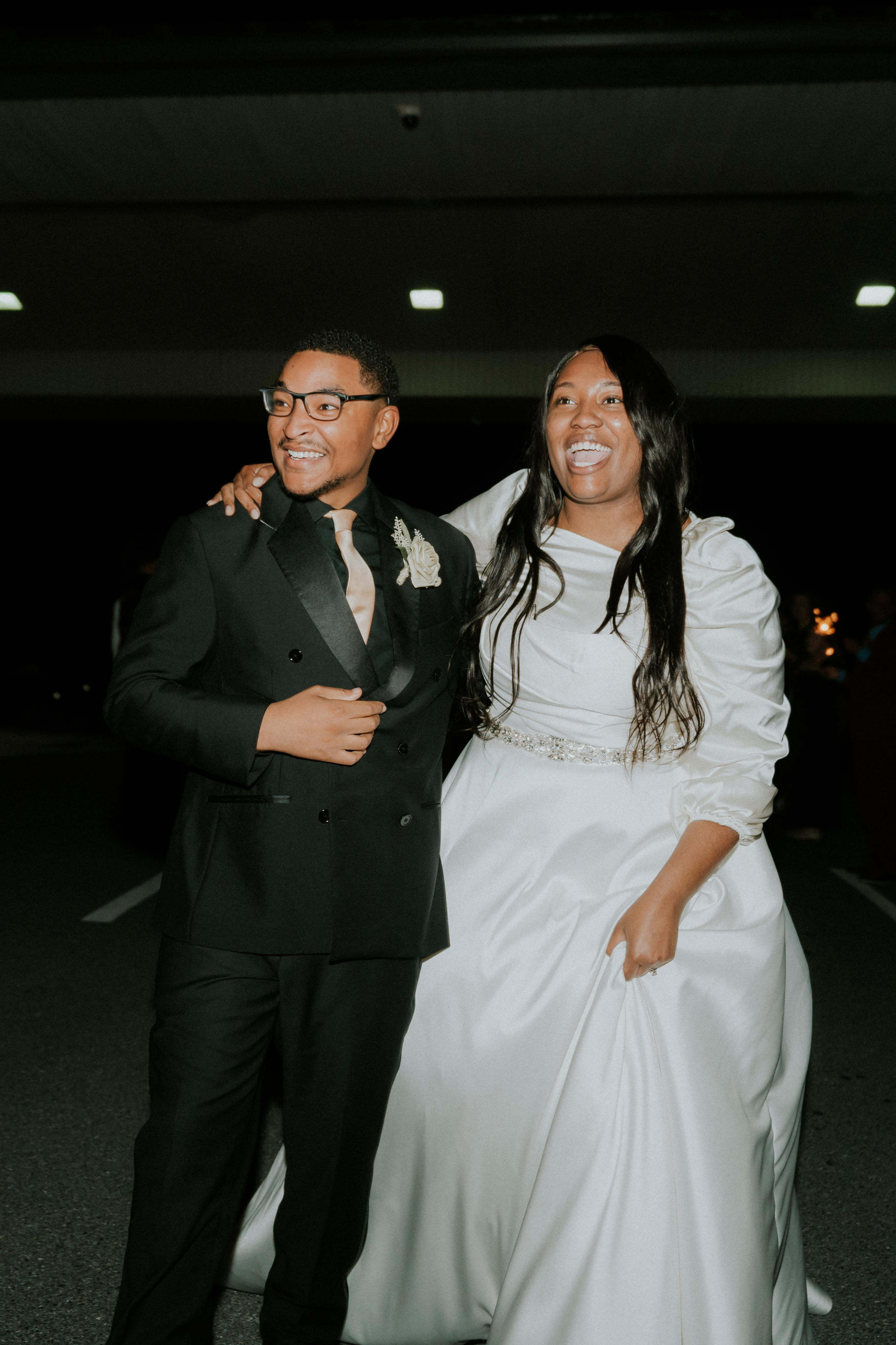 Bride and groom laughing together outside their wedding venue