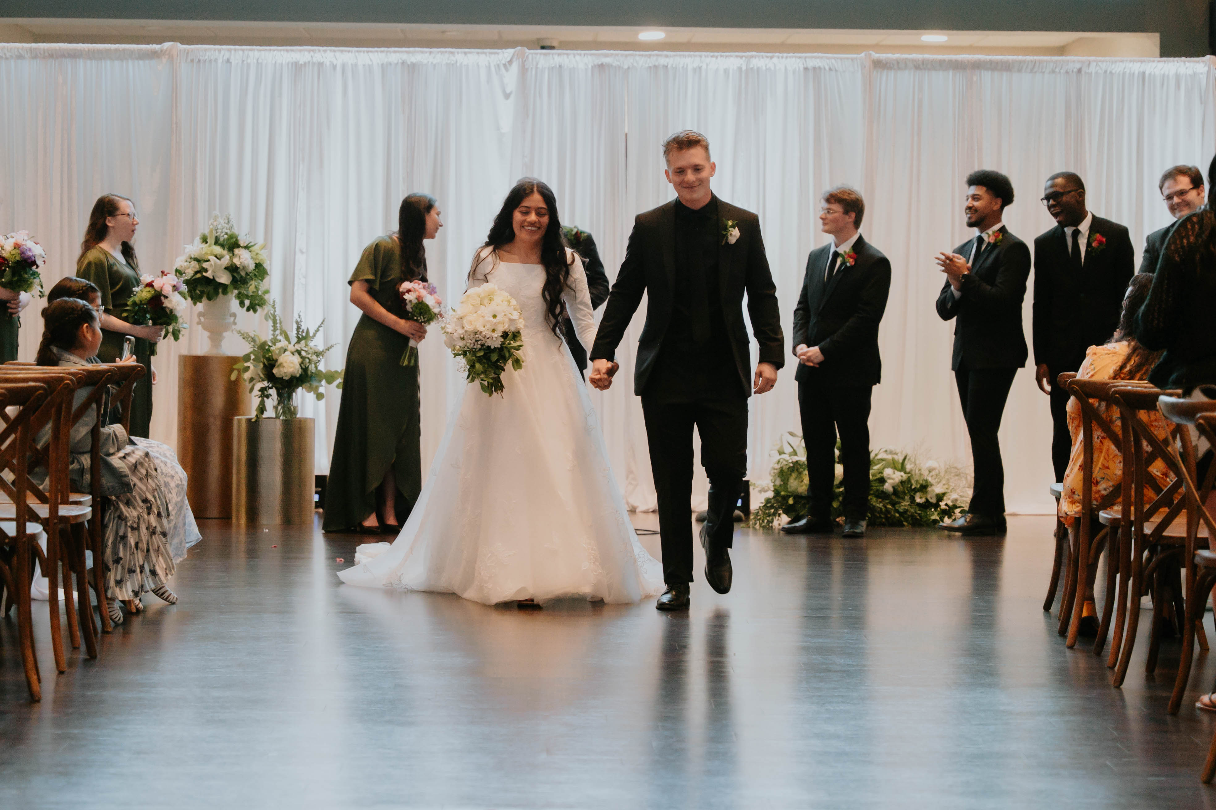 Bride and groom walking down the aisle at their wedding reception